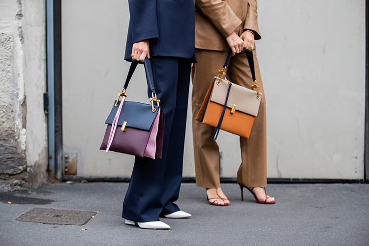 MILAN, ITALY - SEPTEMBER 22: Erika Boldrin wearing brown leather suit, bag, Linda Tol wearing navy suit, two tone bag seen outside Boss during Milan Fashion Week Spring/Summer 2020 on September 22, 2019 in Milan, Italy. (Photo by Christian Vierig/Getty Images)