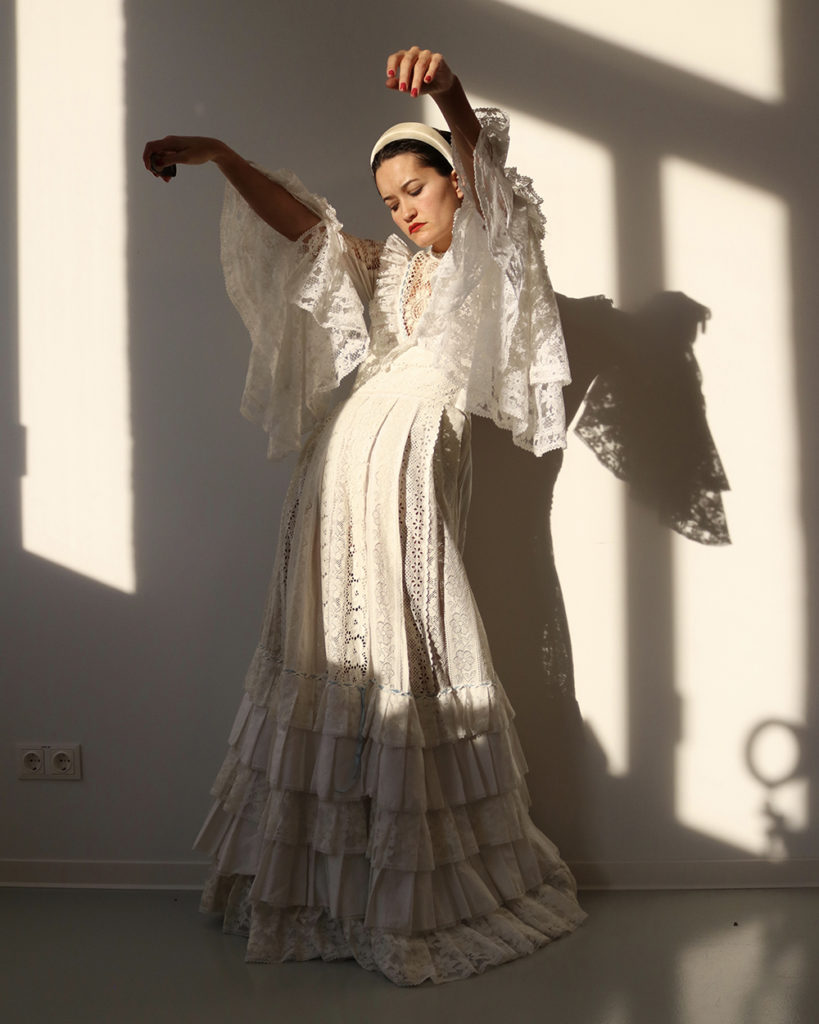 Depop seller Abbey Looker wearing a white lace dress